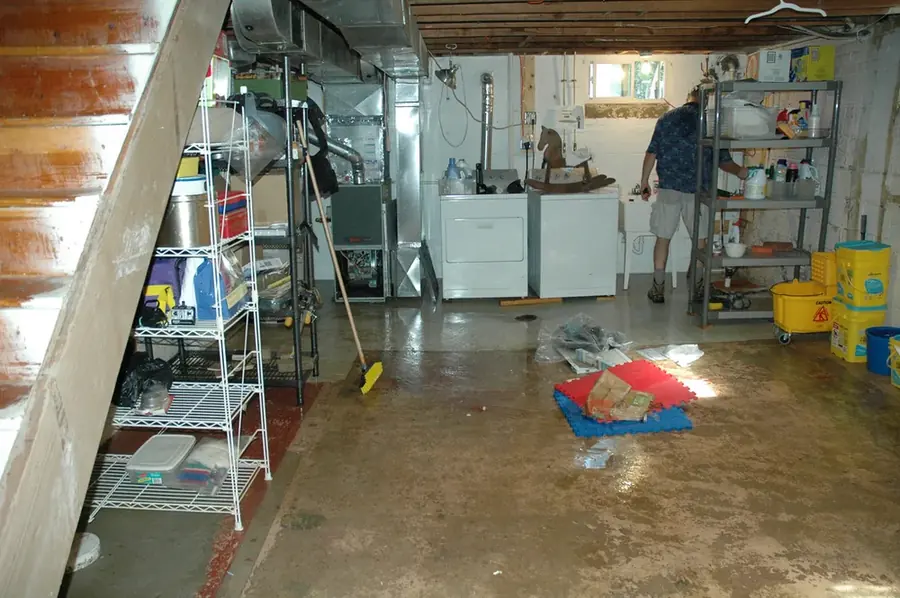 Technician inspecting a leaking dishwasher supply line in a North Hollywood kitchen