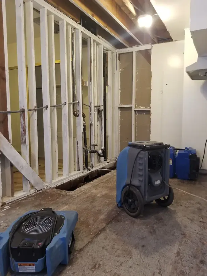 Technician extracting water from a burst pipe flood in a North Hollywood, CA home