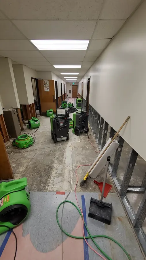 Air movers drying a water damaged corridor in North Hollywood