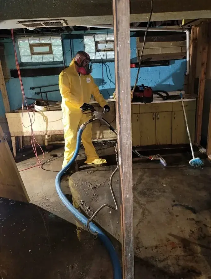 Technician in PPE cleaning a Category 3 sewage backup in a North Hollywood, CA home