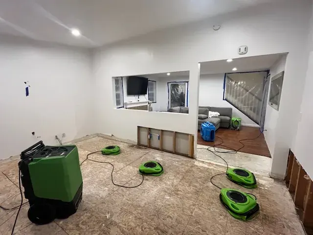 Air movers and a dehumidifier drying a North Hollywood living room after water damage