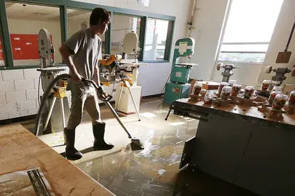 Technician extracting standing water from a flooded North Hollywood living room floor